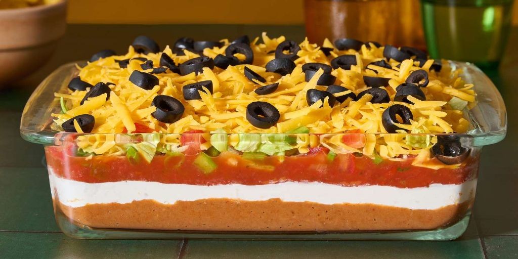 Seven-layer taco dip with fresh salsa and sour cream