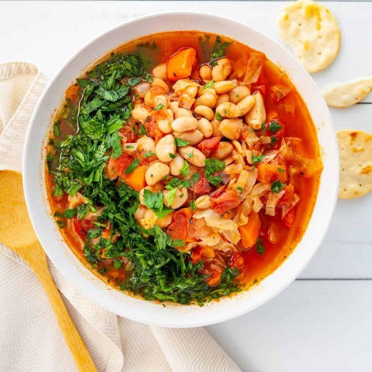 Boiled cabbage and white beans in tomato broth