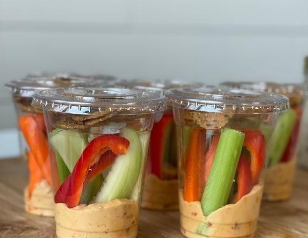Portable hummus and veggie sticks in Tupperware